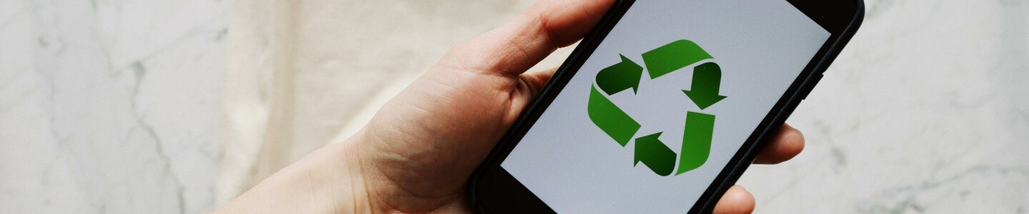 anonymous-crop-person-holding-smartphone-over-white-textile-3850461